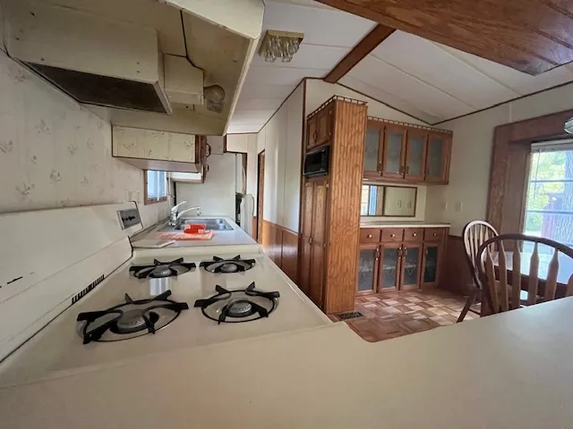 a kitchen with stainless steel appliances granite countertop a stove refrigerator and cabinets