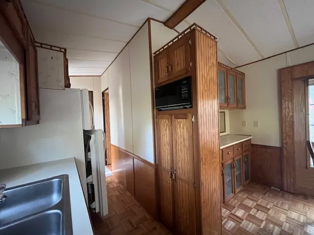 a view of a hallway with wooden shelves