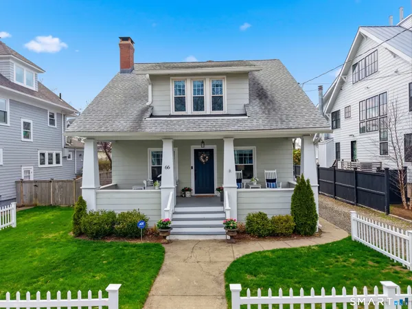 a front view of a house with garden and porch