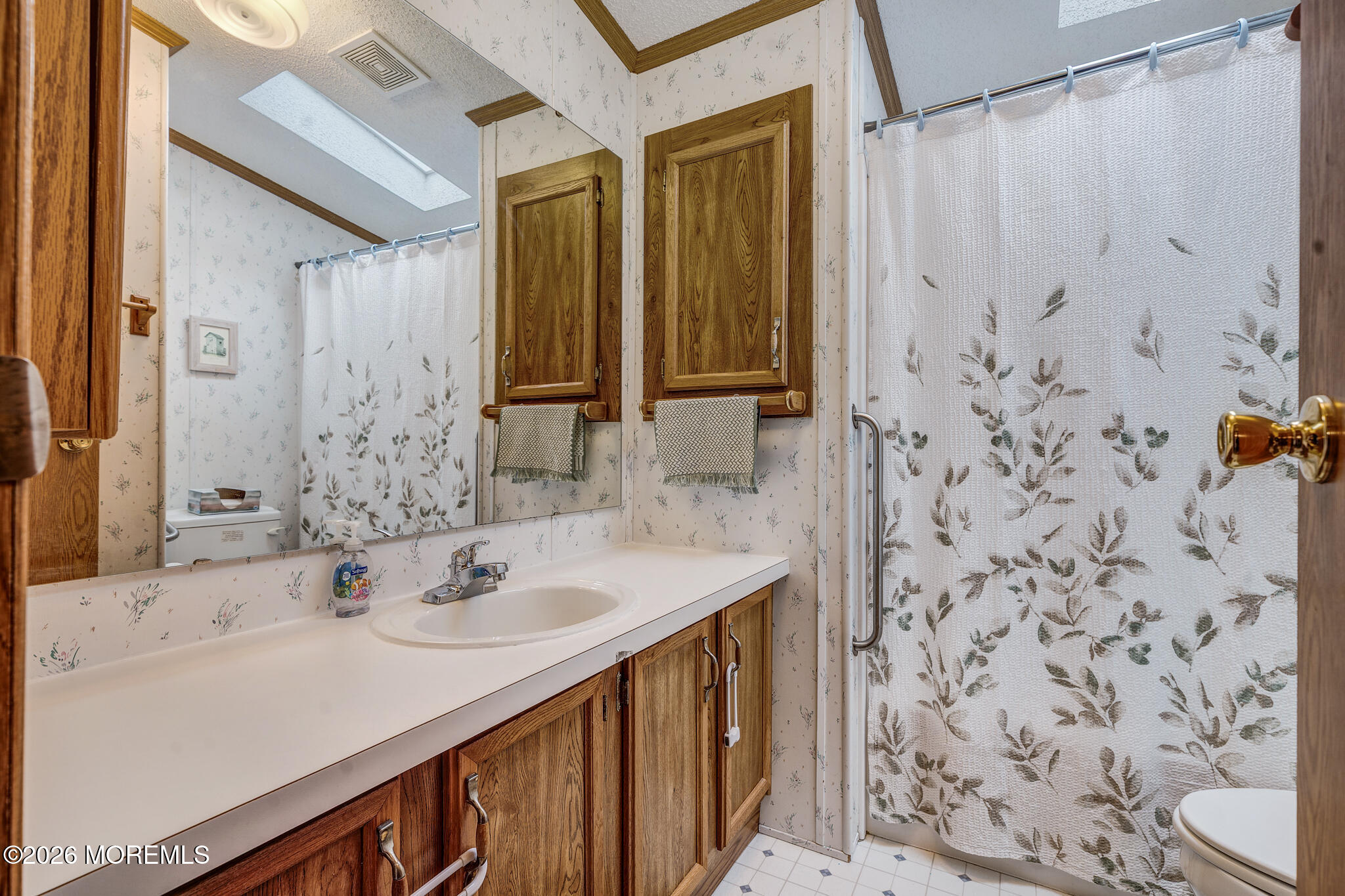 78 Village Road Morganville, NJ 07751 - Photo 16 of 25 a bathroom with a sink and a mirror