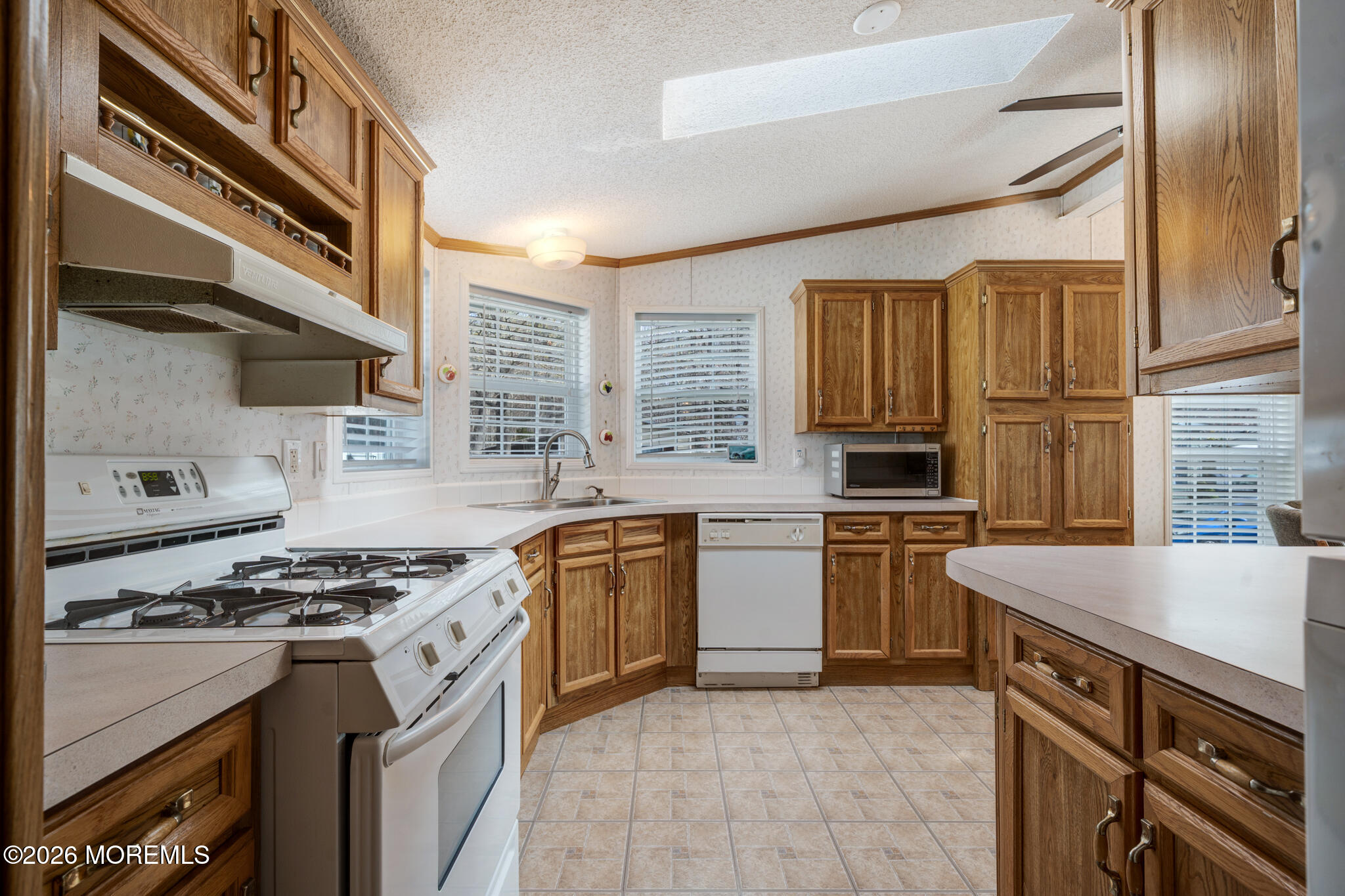 78 Village Road Morganville, NJ 07751 - Photo 6 of 25 a kitchen with stainless steel appliances granite countertop a stove and a sink
