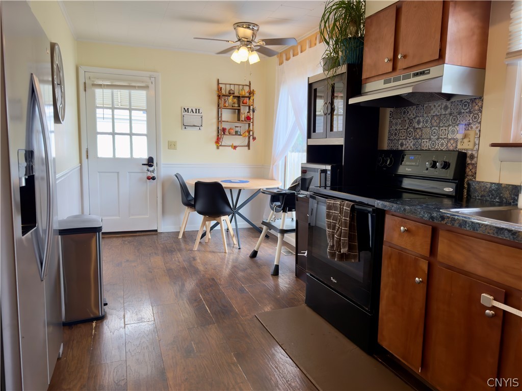 7468 Willey Road Hamilton, NY 13332 - Photo 6 of 19 A bright eat-in kitchen features rich wood cabinets and hardwood flooring.