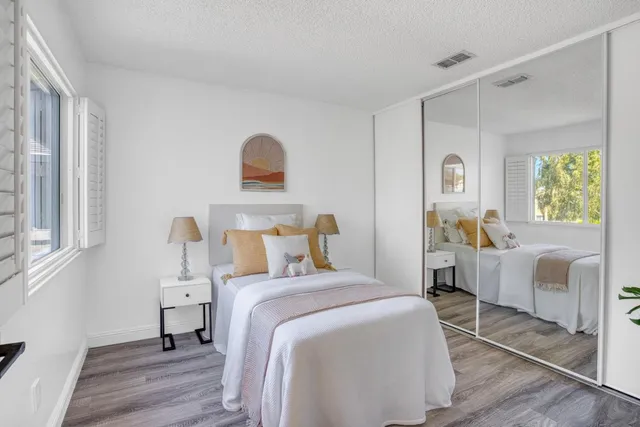 a bedroom with a bed and a couch