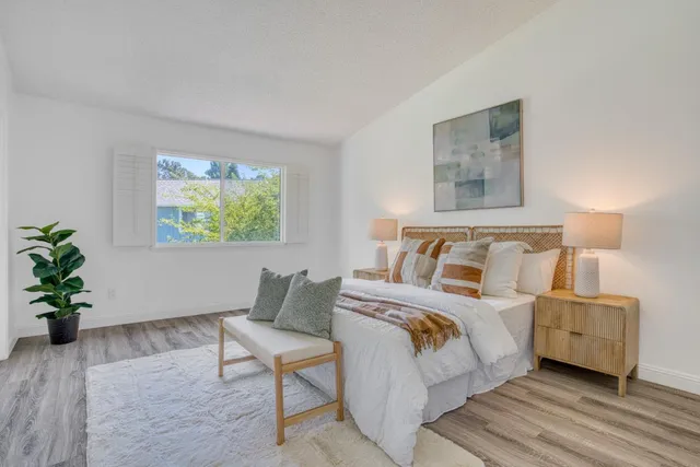 a bedroom with a bed and a painting on the wall