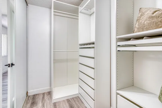 a view of walk in closet with empty racks