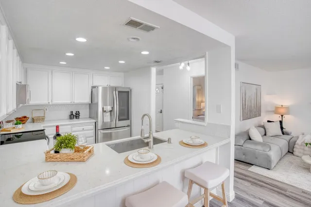 a view of a dining room with furniture and a kitchen