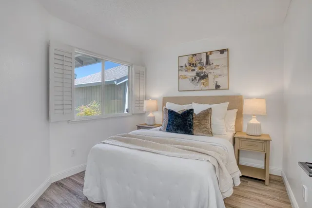 a bedroom with bed and wall painting