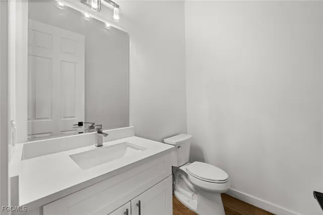 a bathroom with a sink toilet and a mirror