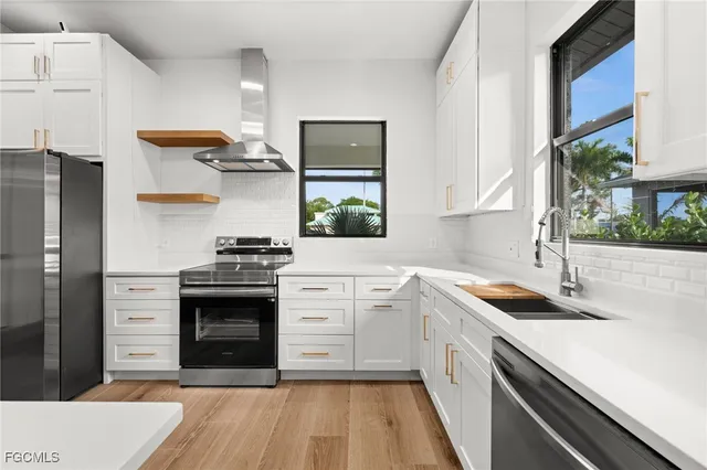 a kitchen with a sink stove and refrigerator