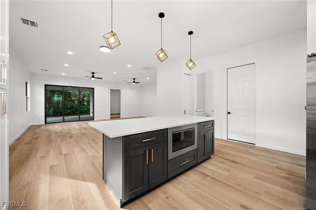 a kitchen with a stove and a wooden floor