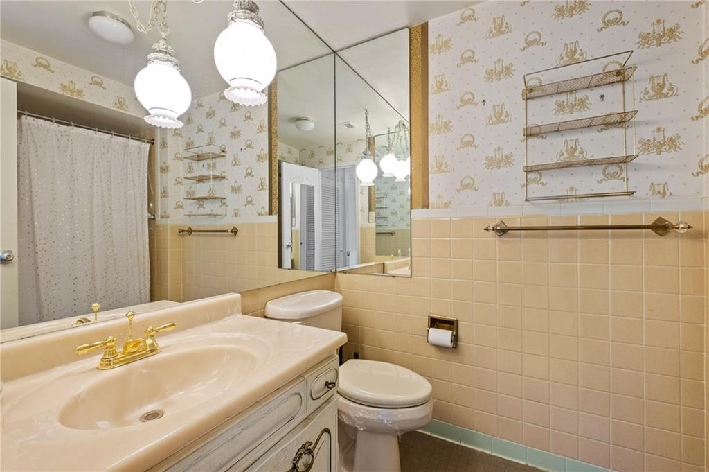 128 North Craig Street, Unit 412 Pittsburgh, PA 15213 - Photo 11 of 17 a bathroom with a sink a toilet and shower