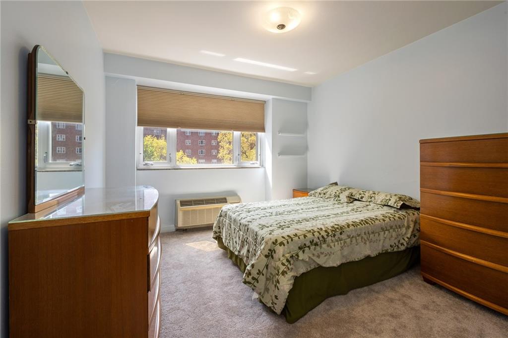 128 North Craig Street, Unit 412 Pittsburgh, PA 15213 - Photo 12 of 17 a bedroom with a bed and a window