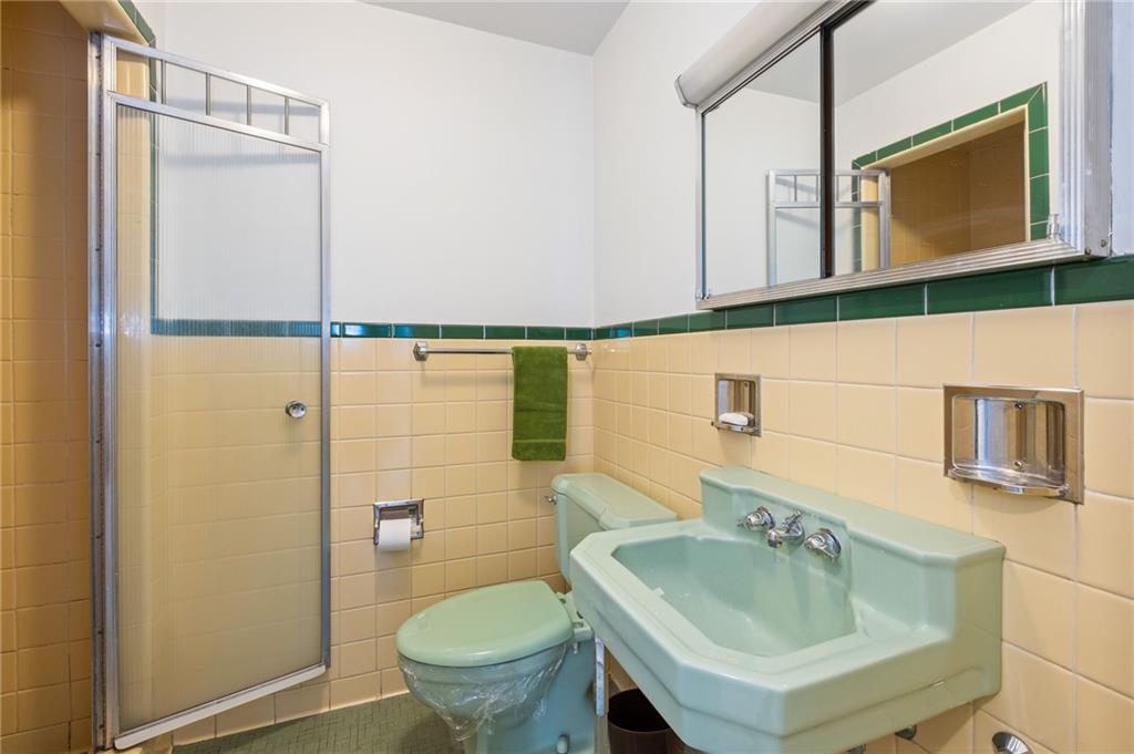 128 North Craig Street, Unit 412 Pittsburgh, PA 15213 - Photo 13 of 17 a bathroom with a sink toilet and mirror