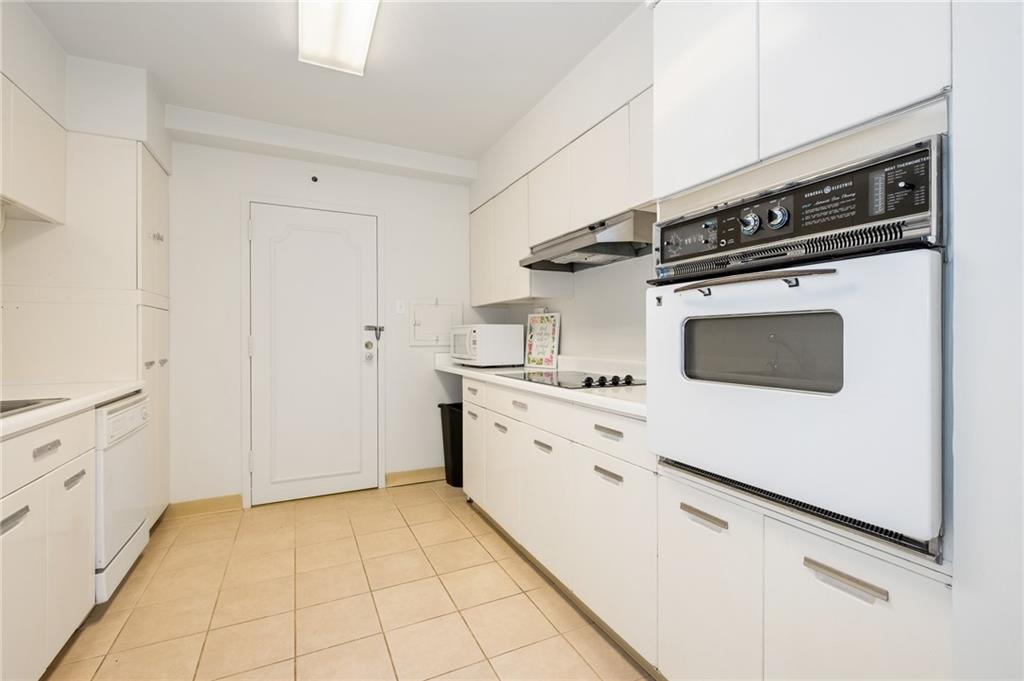 128 North Craig Street, Unit 412 Pittsburgh, PA 15213 - Photo 6 of 17 a kitchen with granite countertop white cabinets and white appliances