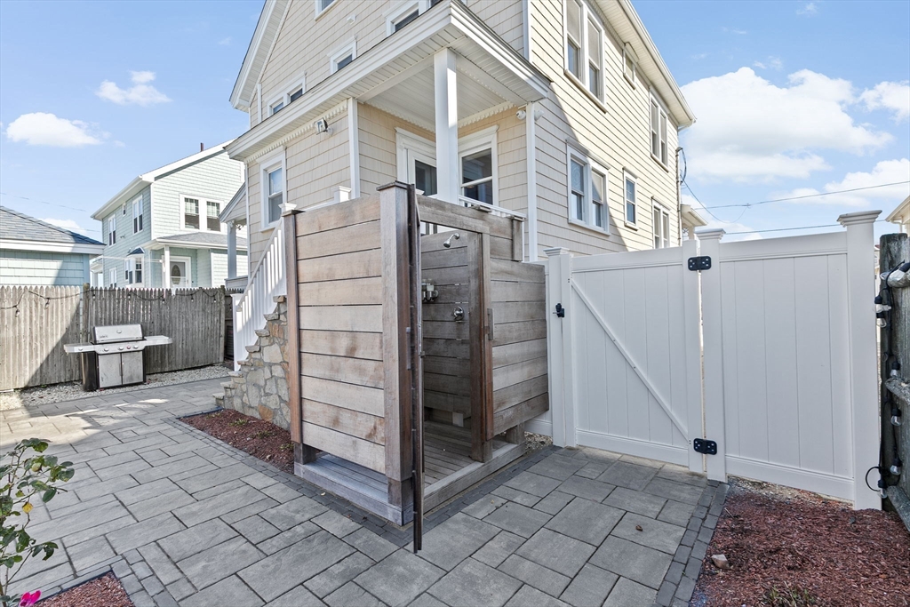 79 F Street Hull, MA 02045 - Photo 11 of 35 a view of a house with a small yard and wooden fence