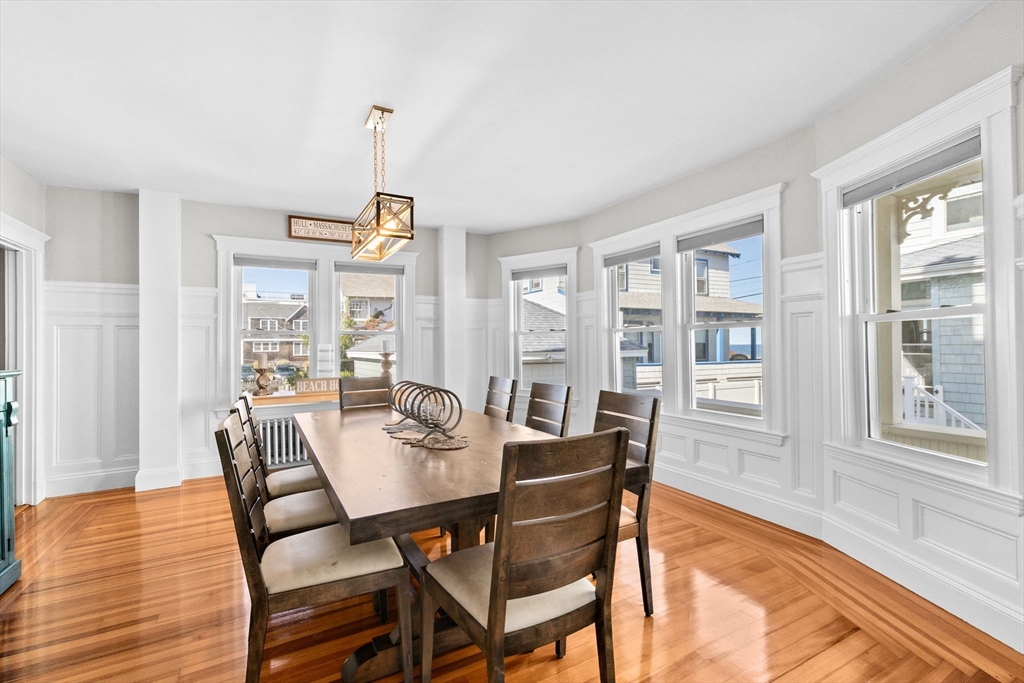 79 F Street Hull, MA 02045 - Photo 14 of 35 a dining room with furniture a chandelier and wooden floor