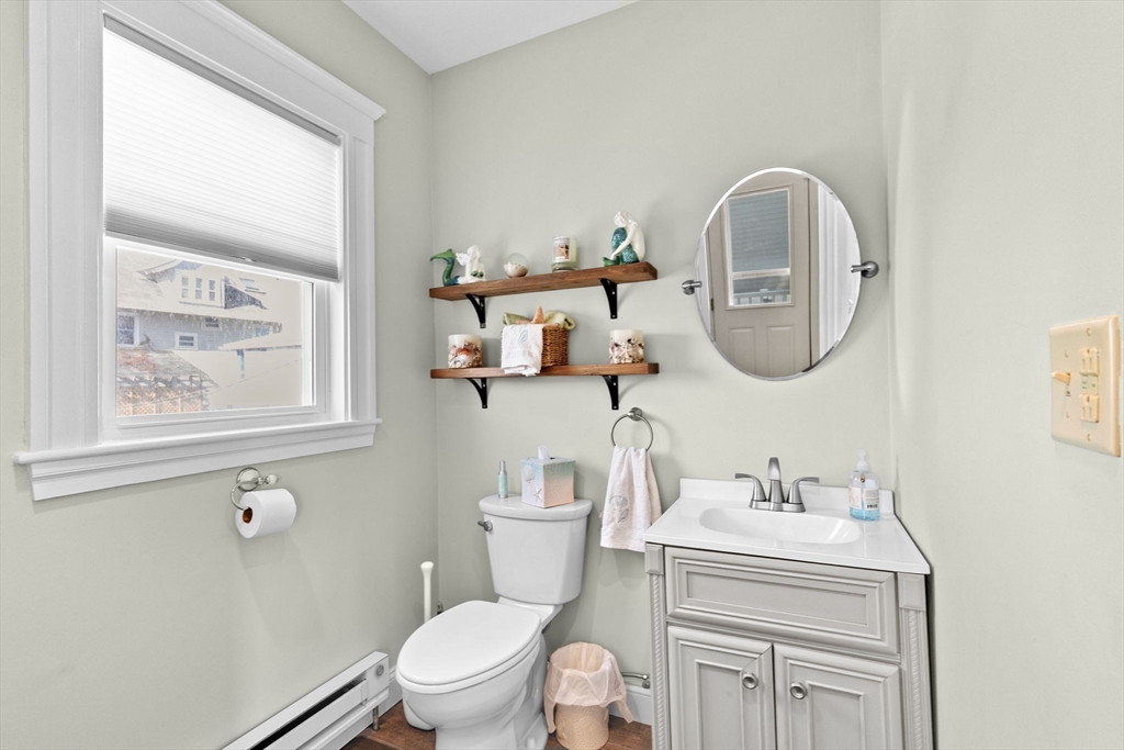 79 F Street Hull, MA 02045 - Photo 15 of 35 a bathroom with a toilet a sink and mirror