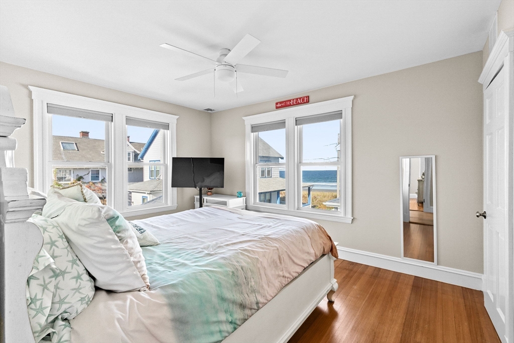 79 F Street Hull, MA 02045 - Photo 20 of 35 a bedroom with a large bed and a flat tv screen
