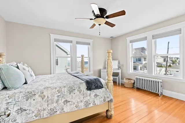 a view of a hallway with wooden floor and chandelier
