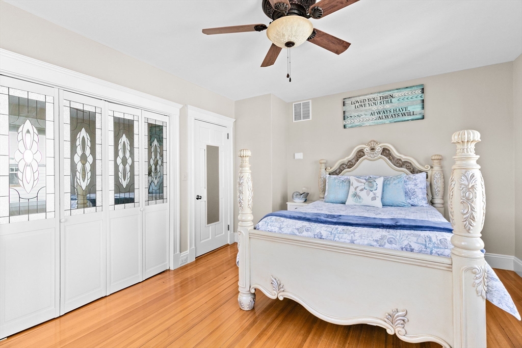 79 F Street Hull, MA 02045 - Photo 23 of 35 a view of a hallway with wooden floor and chandelier