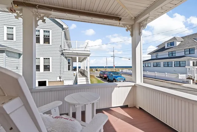 a view of a patio with table and chairs and wooden floor