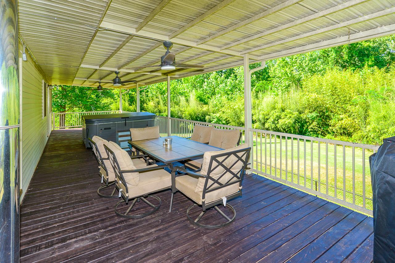 587 Damron Road Estill Springs, TN 37330 - Photo 11 of 30 Wonderful deck off the kitchen & master bedroom has 3 ceiling fan/lights and a jacuzzi has lovely views of the back yard.