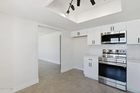 a kitchen with stainless steel appliances a stove cabinets and a refrigerator