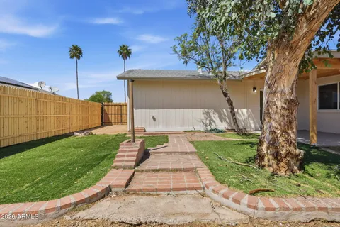 a backyard of a house with sofas