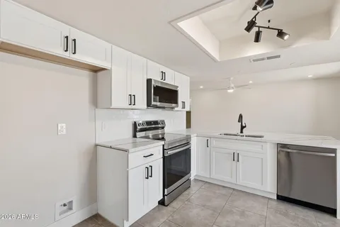 a kitchen with a sink stove and microwave