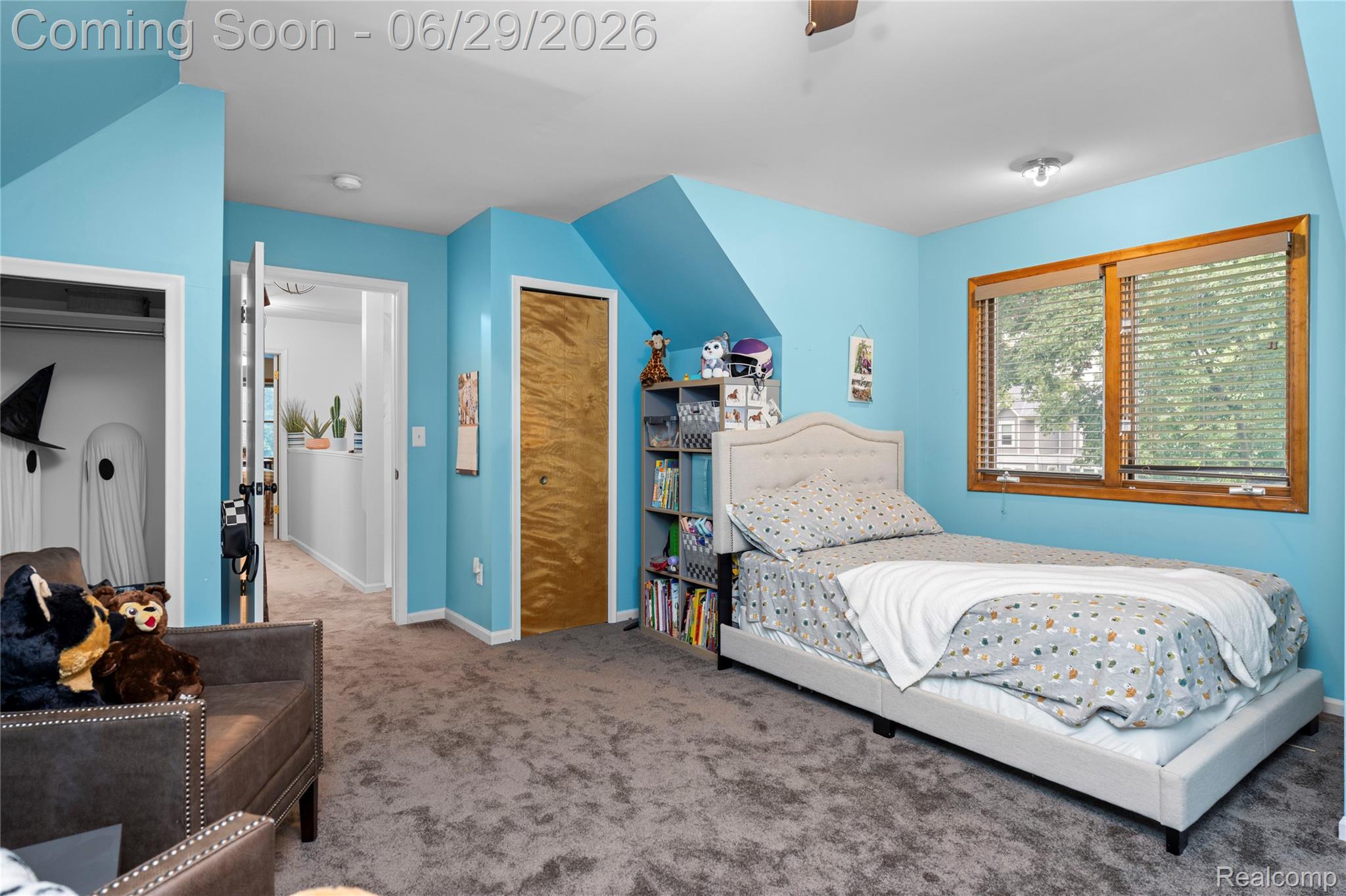6085 Worlington Road Bloomfield Hills, MI 48301 - Photo 51 of 75 Carpeted room with a wooden window frame, a built-in closet with a natural wood door, and a recessed ceiling light