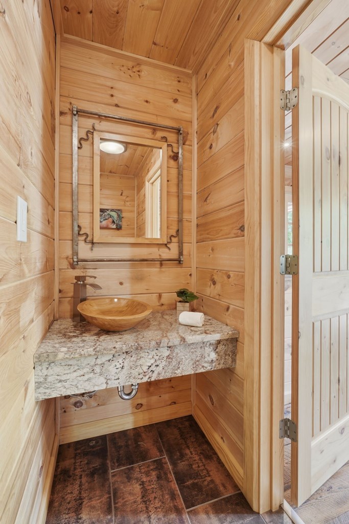 1823 Shoal Creek Road Clarkesville, GA 30523 - Photo 41 of 149 a bathroom with a granite countertop sink and a mirror