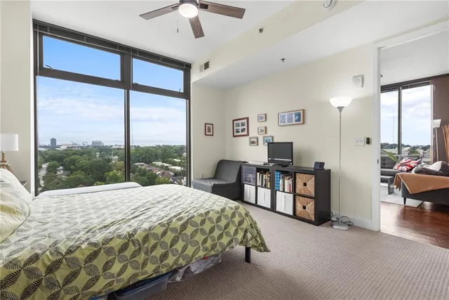 a bedroom with a large bed and a large window