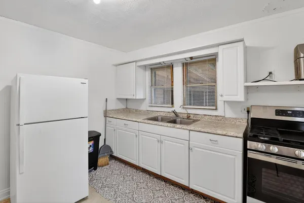 a white toilet sitting next to a bathroom sink and vanity