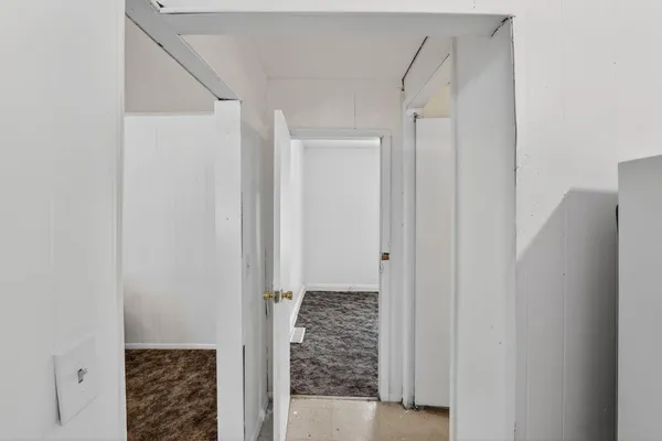 a view of empty room with window and wooden floor