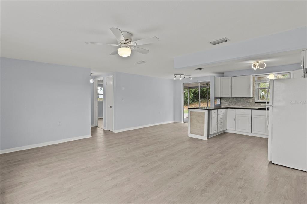 1623 Plum Tree Road Holiday, FL 34690 - Photo 9 of 33 a view of a kitchen with a sink cabinets and wooden floor