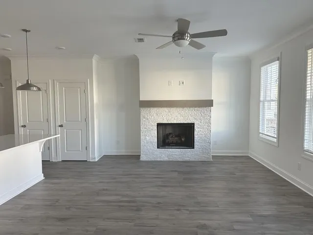a view of a livingroom with a fireplace and window