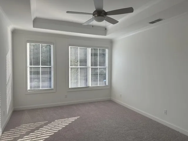 an empty room with a empty space and windows