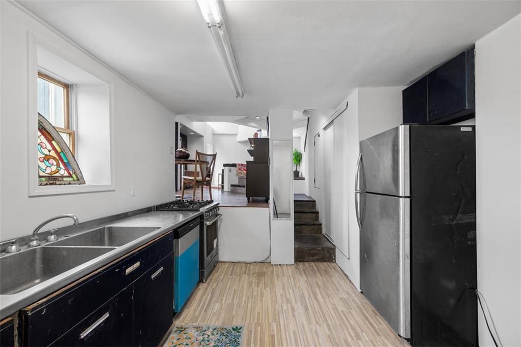 23 Seneca Street Pittsburgh, PA 15219 - Photo 14 of 38 a kitchen with a sink appliances and cabinets