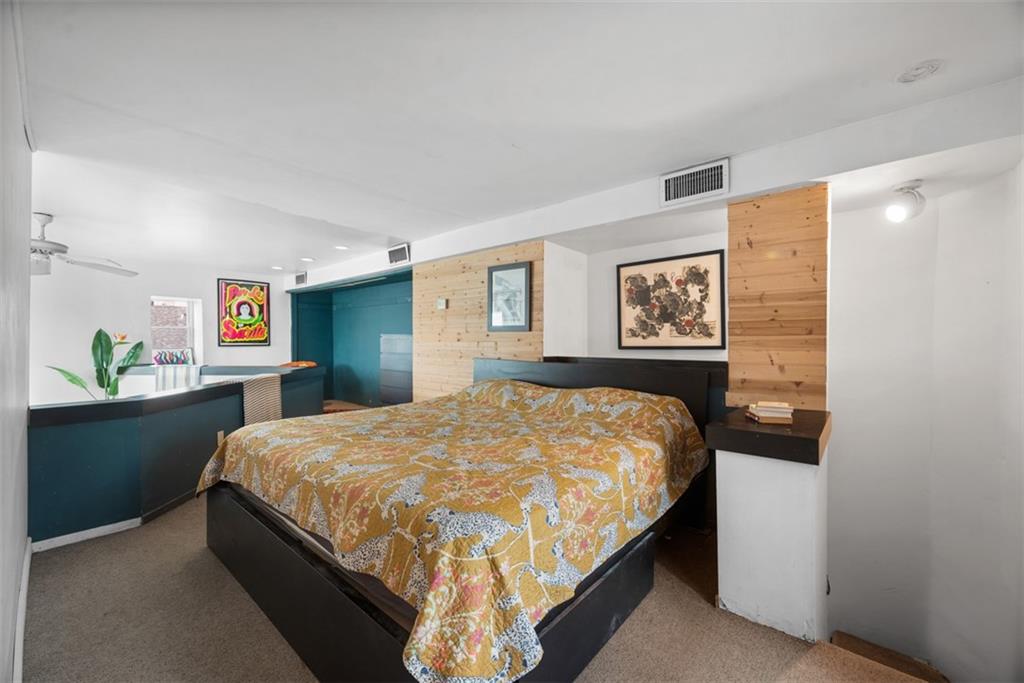 23 Seneca Street Pittsburgh, PA 15219 - Photo 16 of 38 a bed sitting in a bedroom and painting on the wall in a room