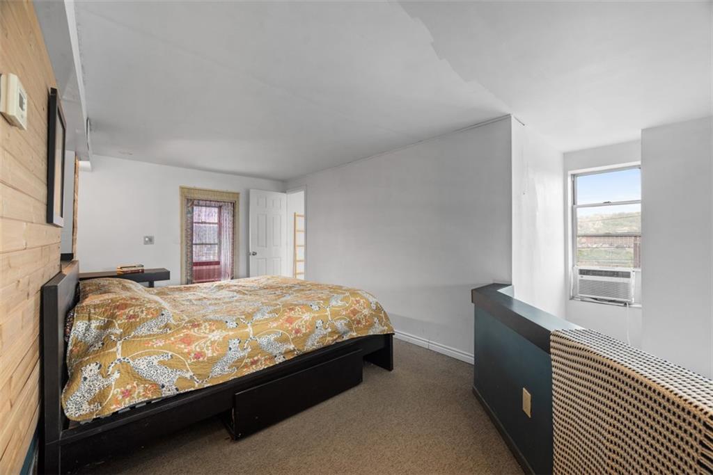 23 Seneca Street Pittsburgh, PA 15219 - Photo 17 of 38 a bed sitting in a bedroom next to a window