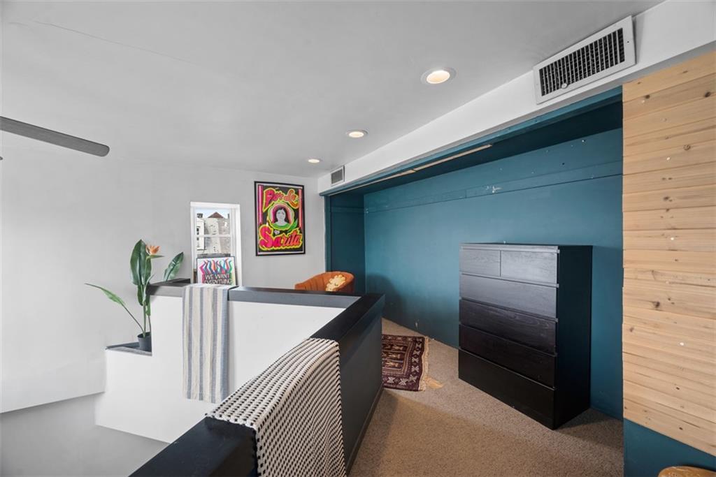 23 Seneca Street Pittsburgh, PA 15219 - Photo 20 of 38 a hallway with a couch and furniture