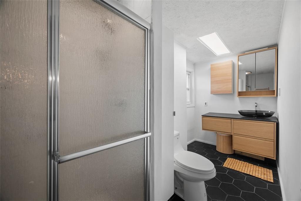 23 Seneca Street Pittsburgh, PA 15219 - Photo 23 of 38 a bathroom with a sink toilet and shower