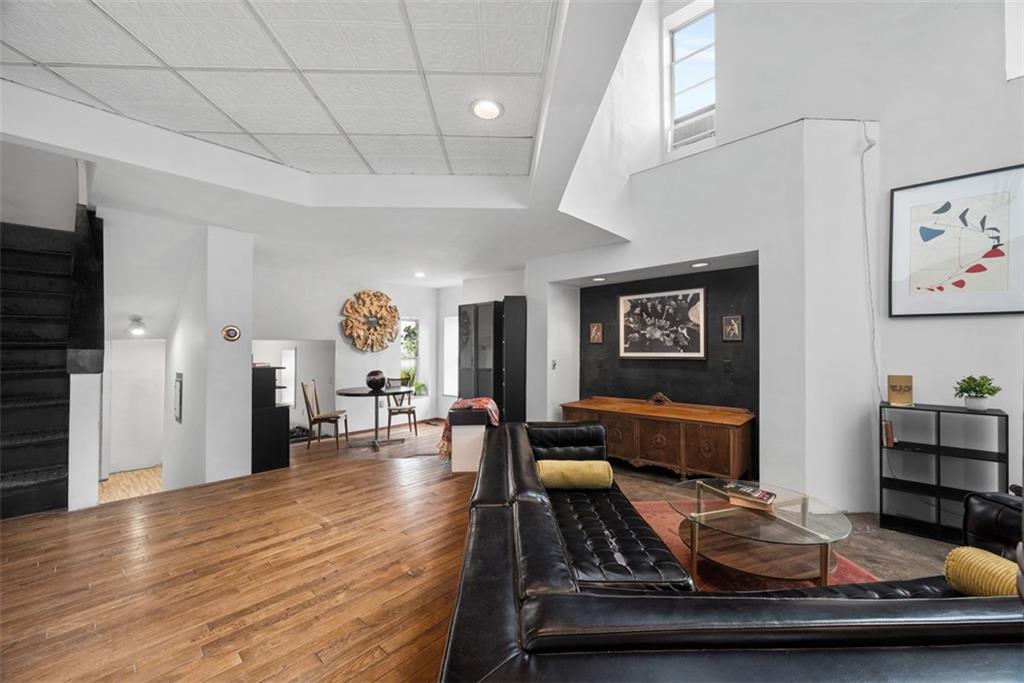 23 Seneca Street Pittsburgh, PA 15219 - Photo 7 of 38 a living room with furniture and wooden floor
