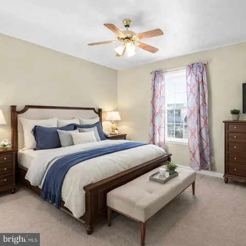 a bedroom with bed and a chandelier