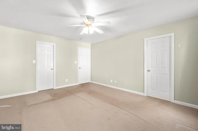 a view of an empty room with a fan
