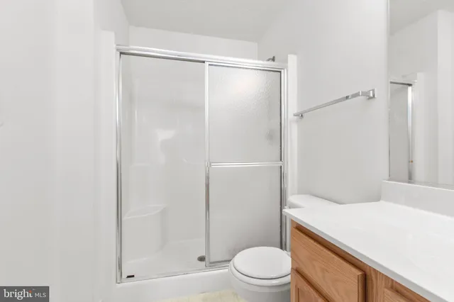 a bathroom with a shower a toilet and sink