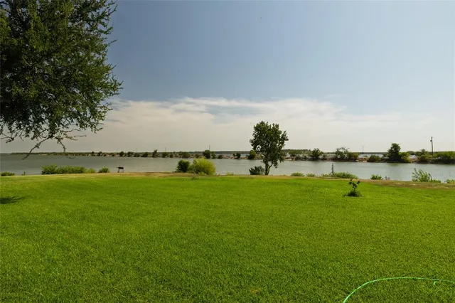 a view of a lake with houses in the background