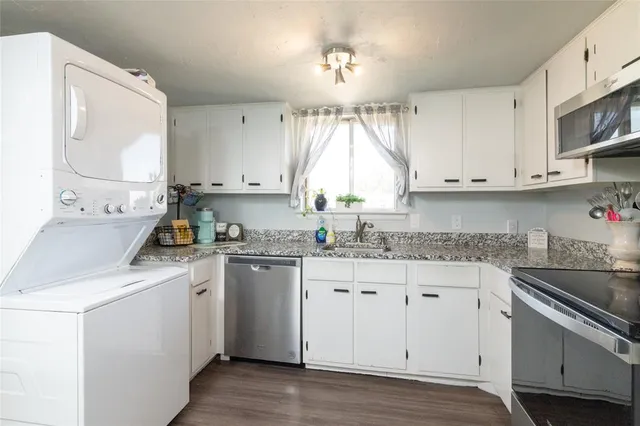 a kitchen with appliances cabinets and a sink