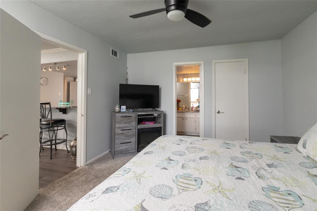 108 Harbor Drive, Unit 204 Runaway Bay, TX 76426 - Photo 14 of 22 a bedroom with a bed and a flat screen tv