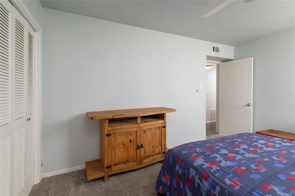 108 Harbor Drive, Unit 204 Runaway Bay, TX 76426 - Photo 17 of 22 a bedroom with a bed and a window